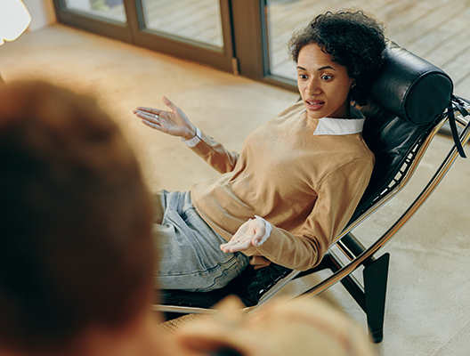 A young woman receiving supportive counseling in a therapist’s office